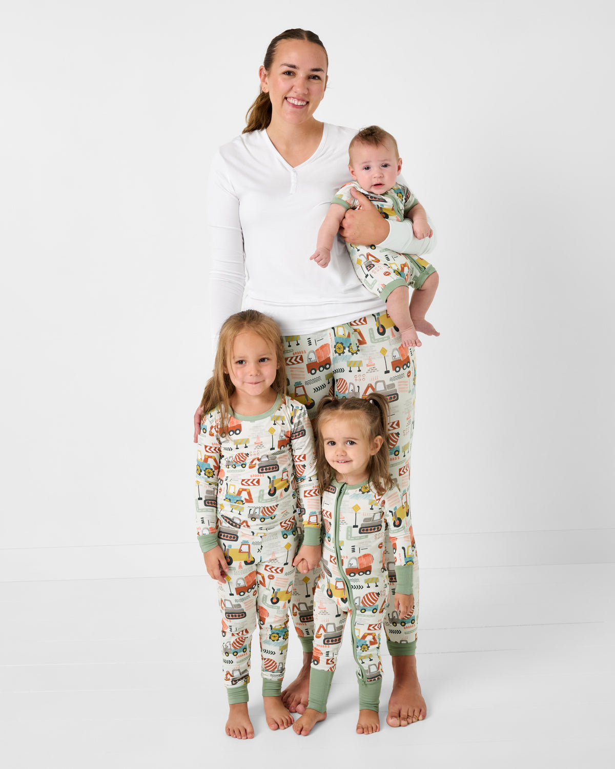 Mother and three children wearing matching Mini Builders pajamas