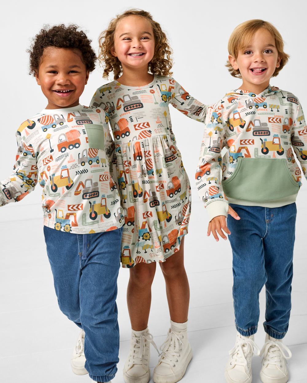 Group of three children wearing Mini Builders play styles