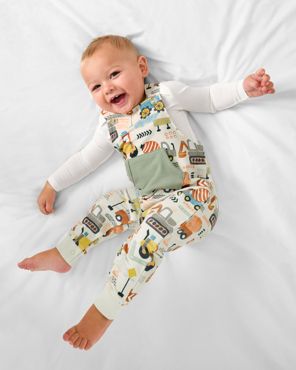 Aerial view of baby wearing the Mini Builders Overall Romper
