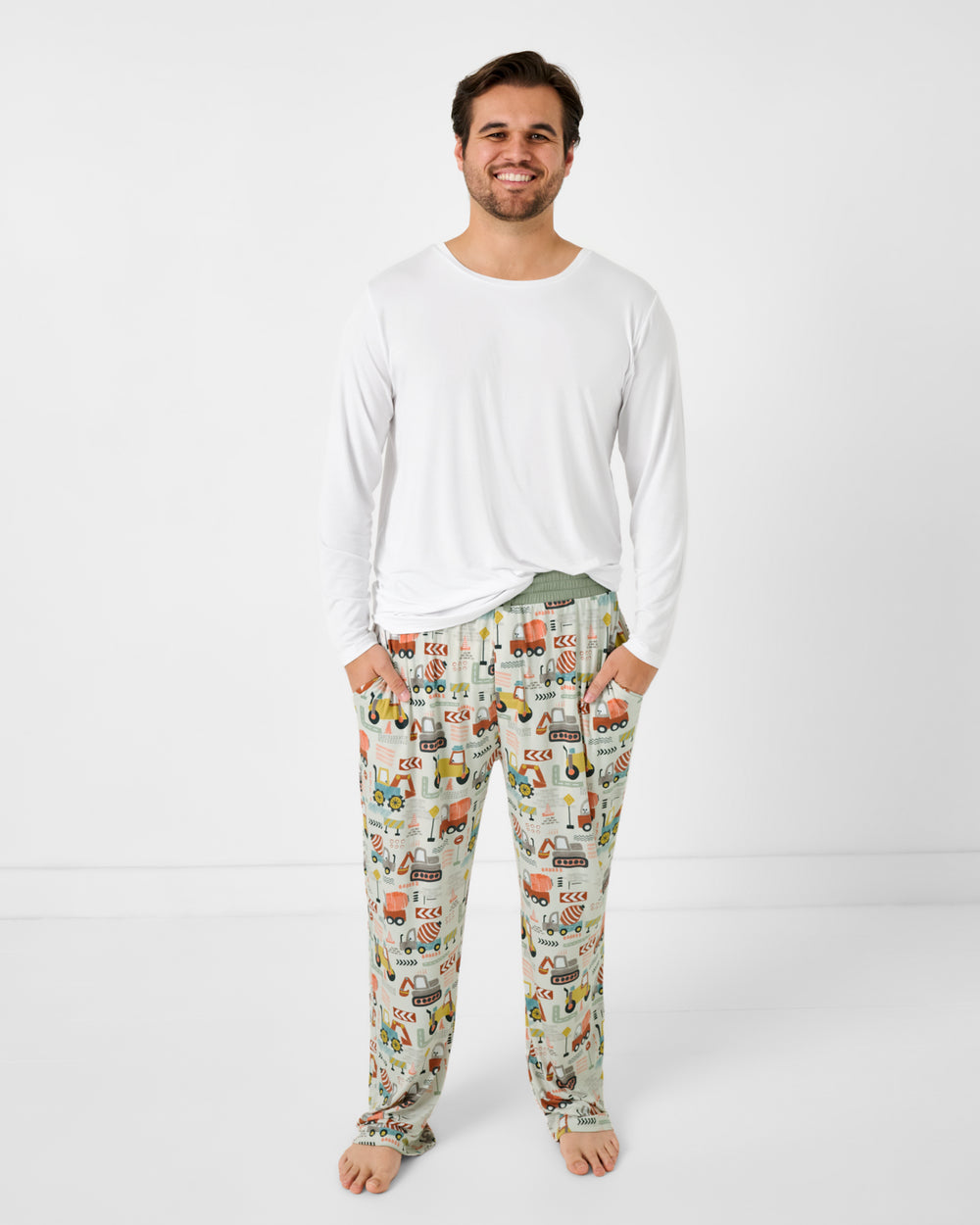 Standing man wearing the Mini Builders Men's Pajama Pants with a white bamboo pj top