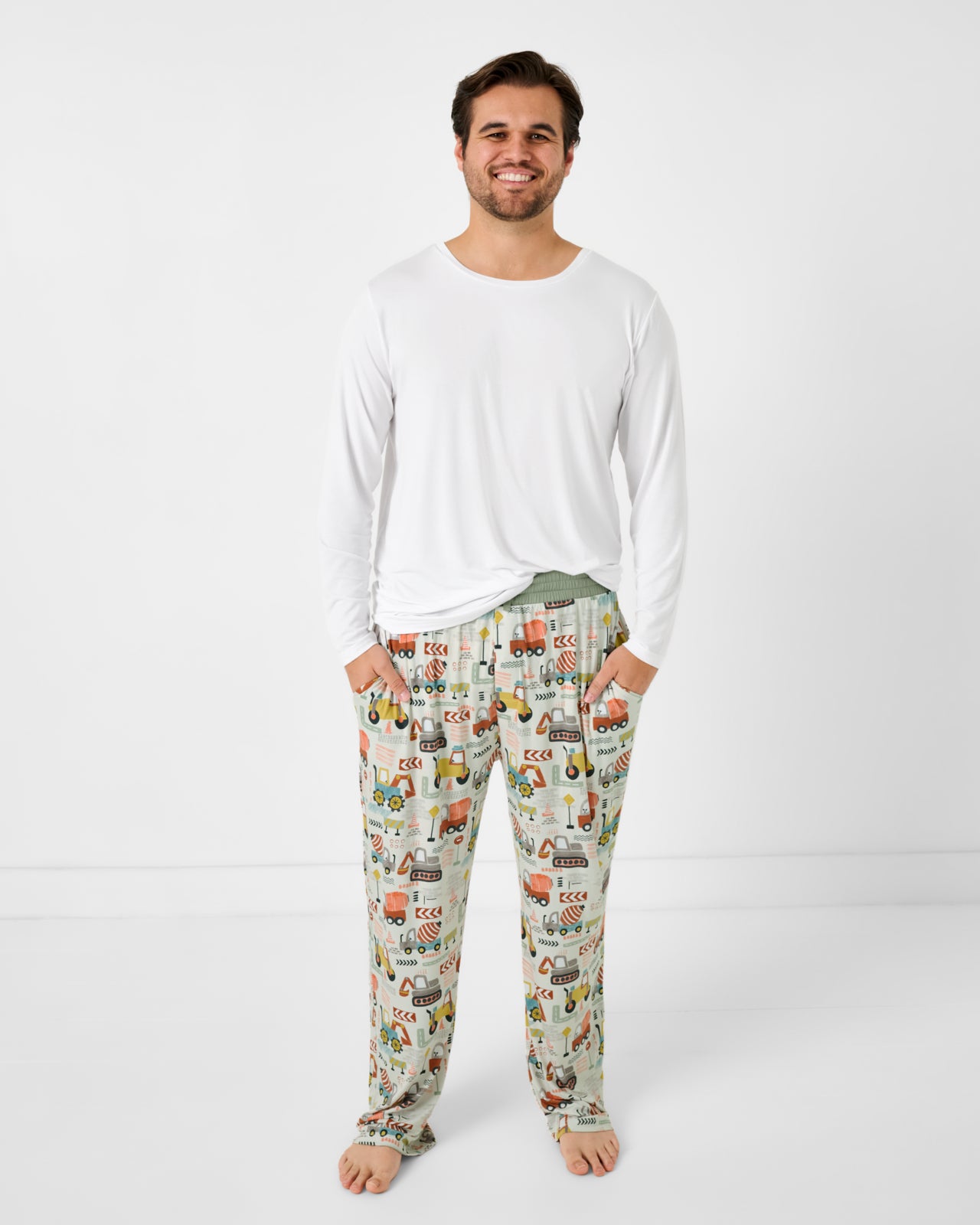 Standing man wearing the Mini Builders Men's Pajama Pants with a white bamboo pj top
