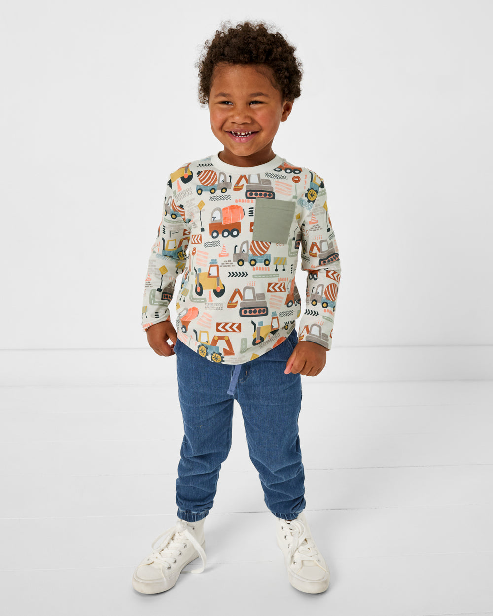 Boy wearing the Mini Builders Relaxed Pocket Tee with blue denim joggers