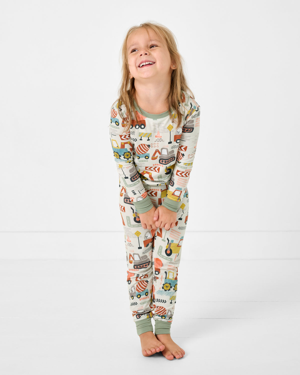 Standing girl wearing the Mini Builders Two-Piece Pajama Set