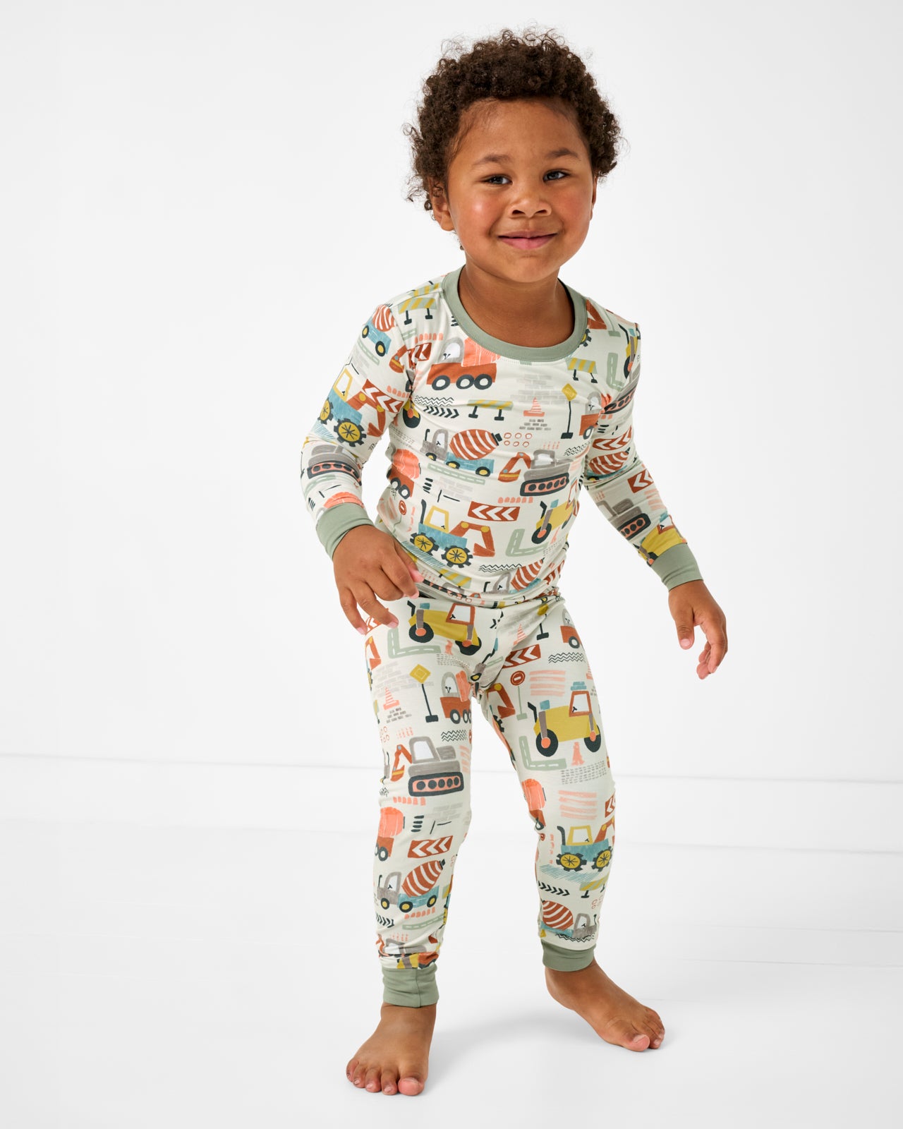 Standing boy wearing the Mini Builders Two-Piece Pajama Set