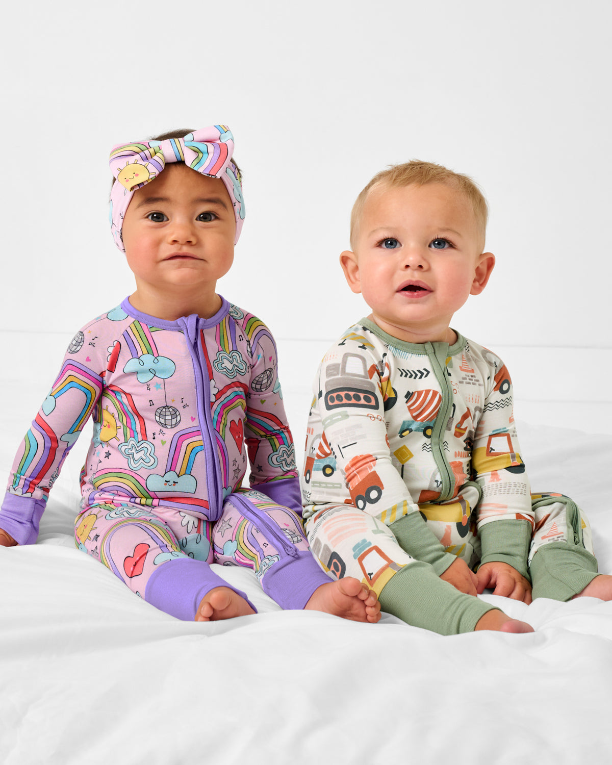 Sitting babies wearing Disco Rainbows and Mini Builders Zippys
