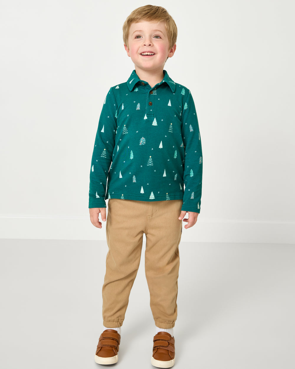Boy wearing the Twinkling Trees Polo Shirt with khaki joggers