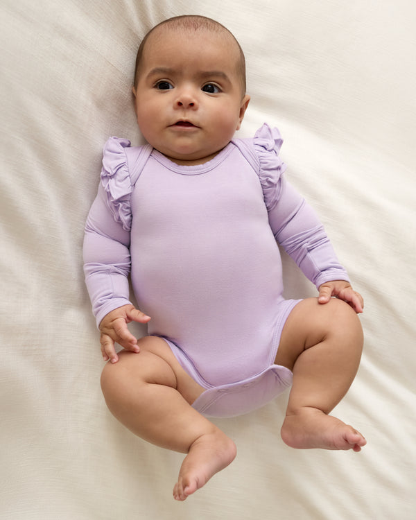 Newborn wearing the Misty Lavender Flutter Bodysuit