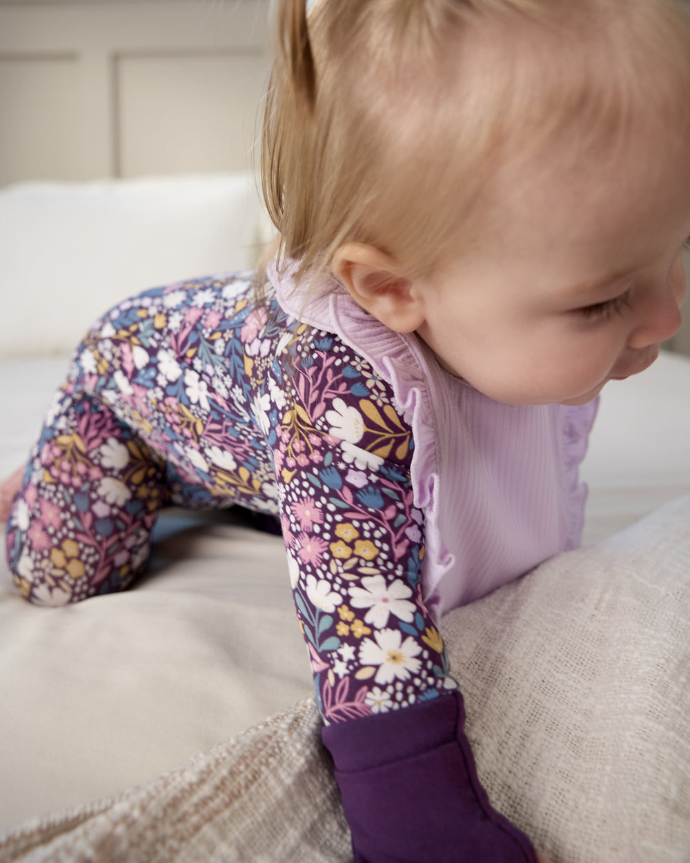 Crawling baby wearing the Misty Lavender Ribbed Ruffle Bib