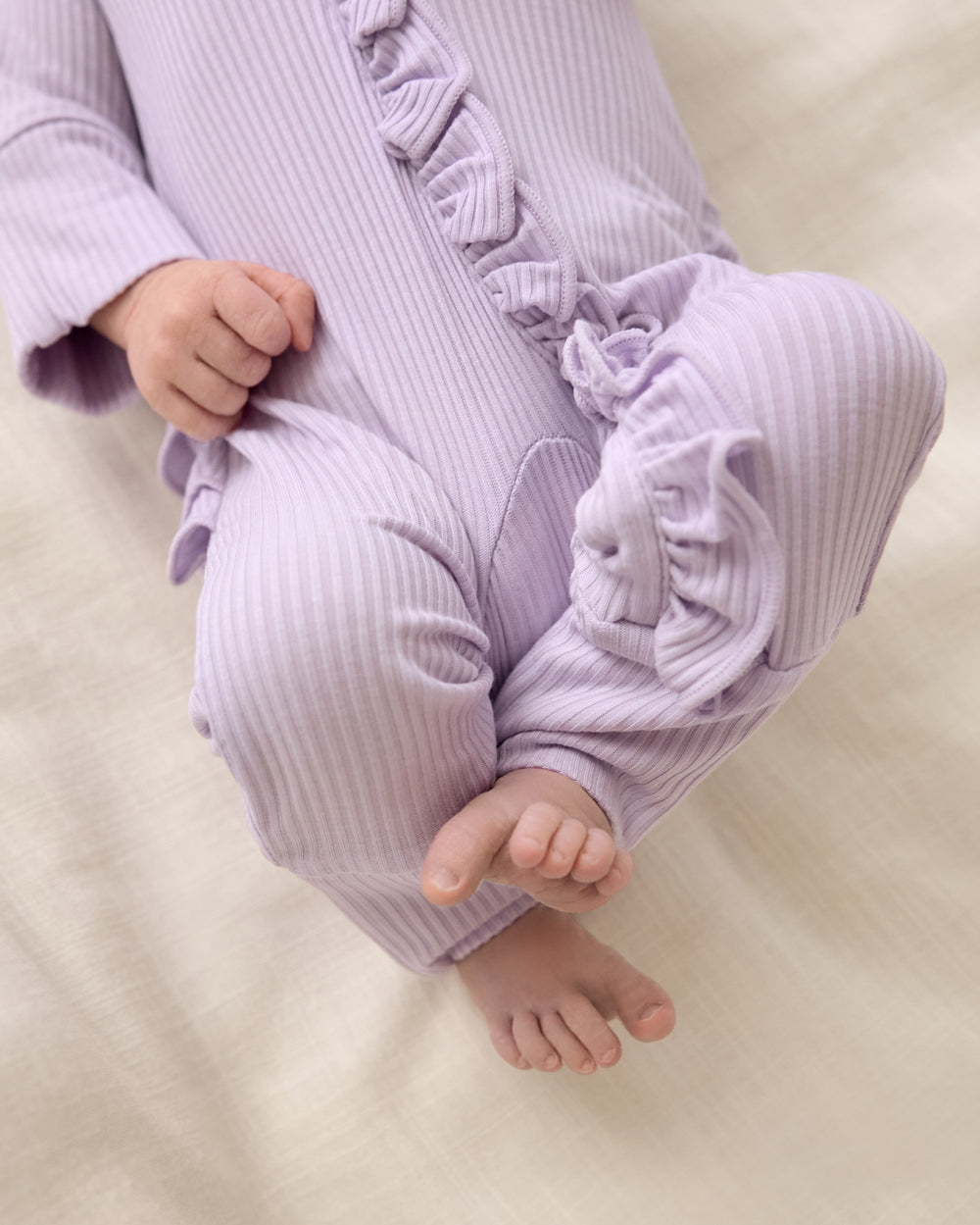 Close up of the ruffle detail on the Misty Lavender Ribbed Ruffle Zippy