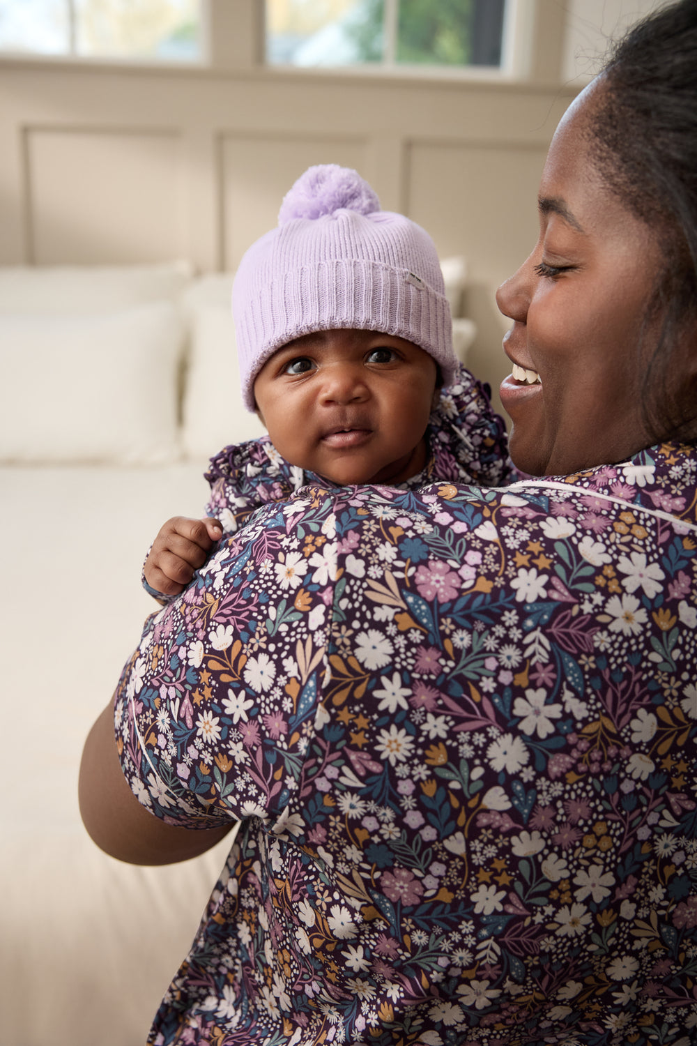 Mother holding baby wearing the Misty Lavender Sweater Beanie Hat