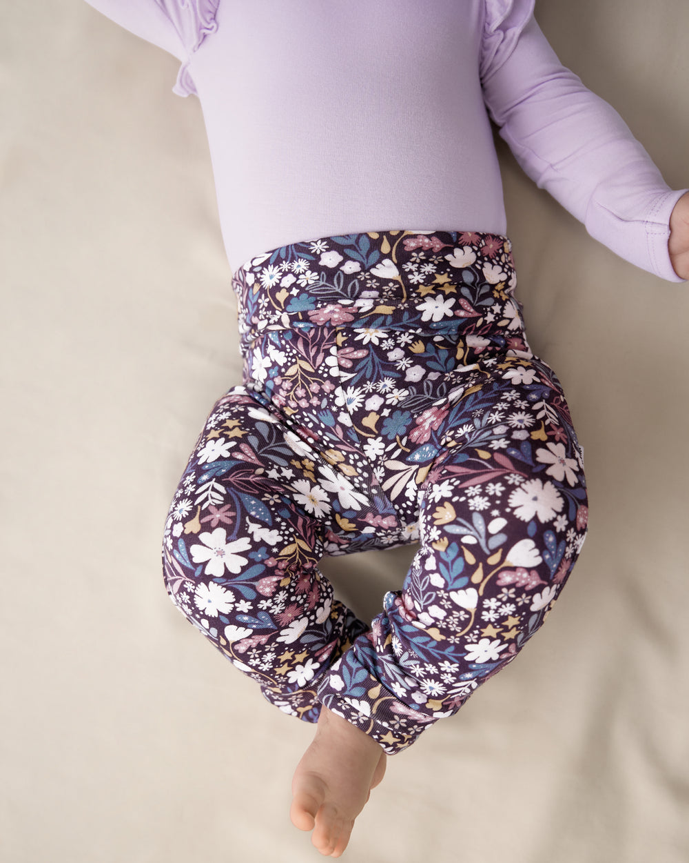 Close up of newborn wearing the Midnight Petals Fold Over Legging 