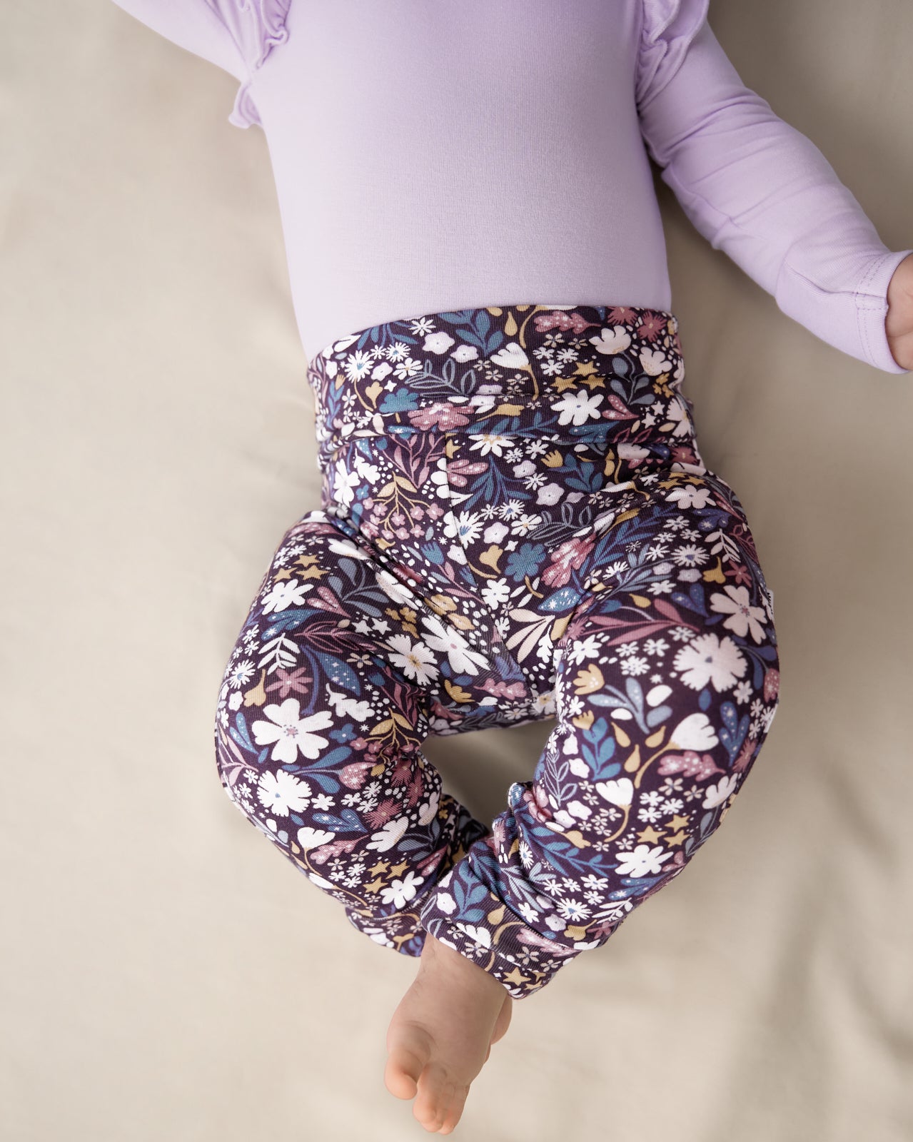 Close up of newborn wearing the Midnight Petals Fold Over Legging 