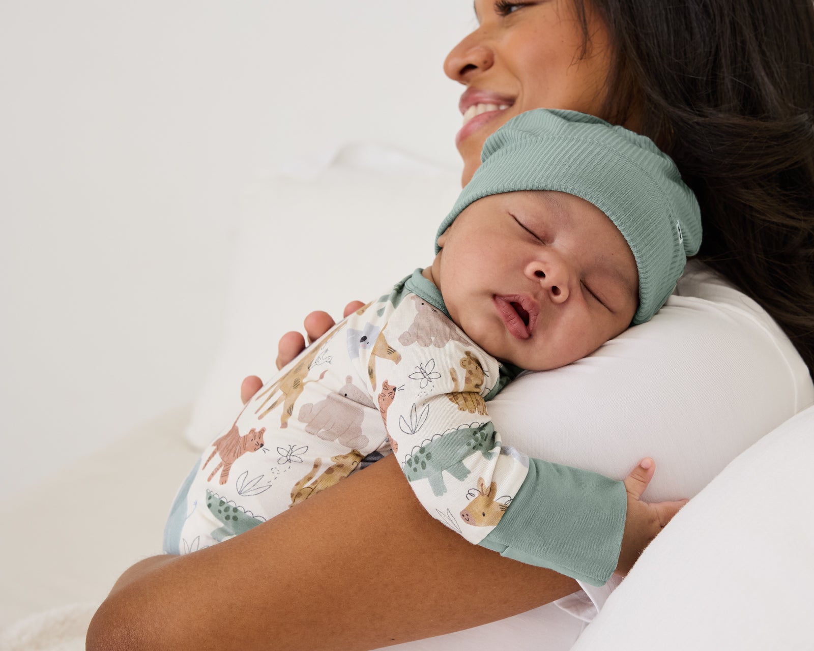 Woman holding newborn baby wearing the Willow Ribbed Infant Beanie