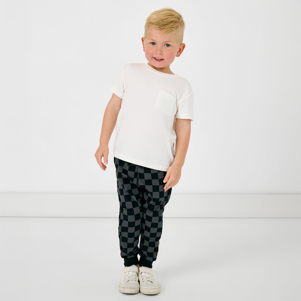 Standing child wearing the Monochrome Checks Jogger with a white tshirt