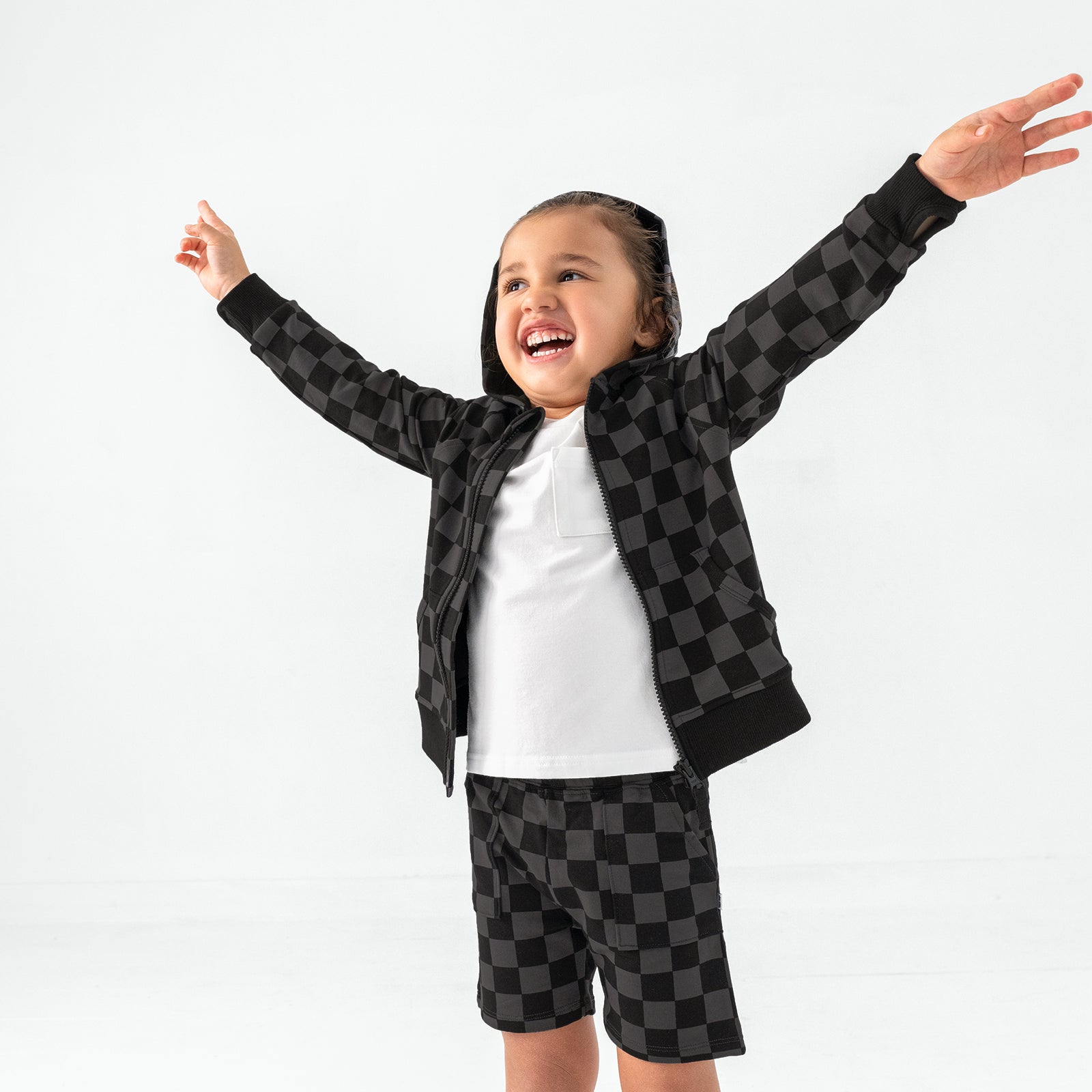 Posing girl wearing the Monochrome Checks Shorts and Hoodie
