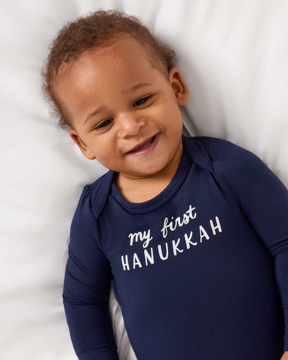 Close up aerial view of baby wearing the My First Hanukkah Bodysuit