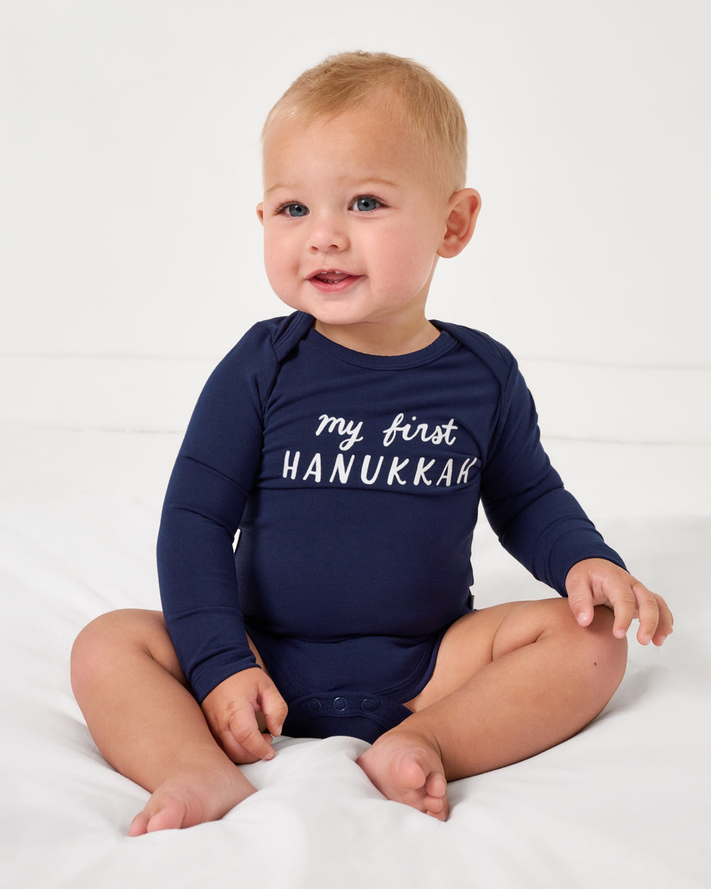 Sitting baby wearing the My First Hanukkah Bodysuit