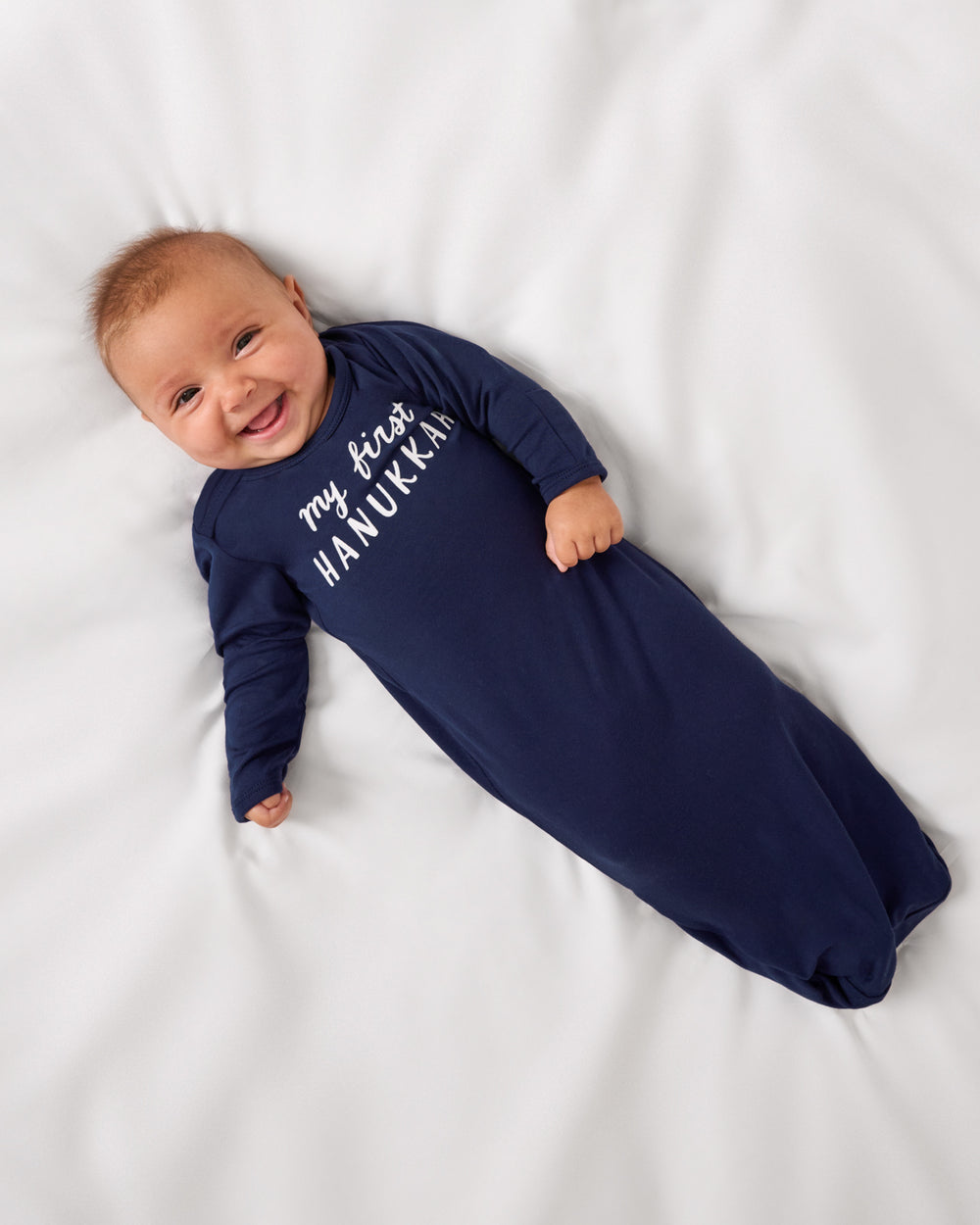 Aerial view of baby wearing the My First Hanukkah Infant Gown