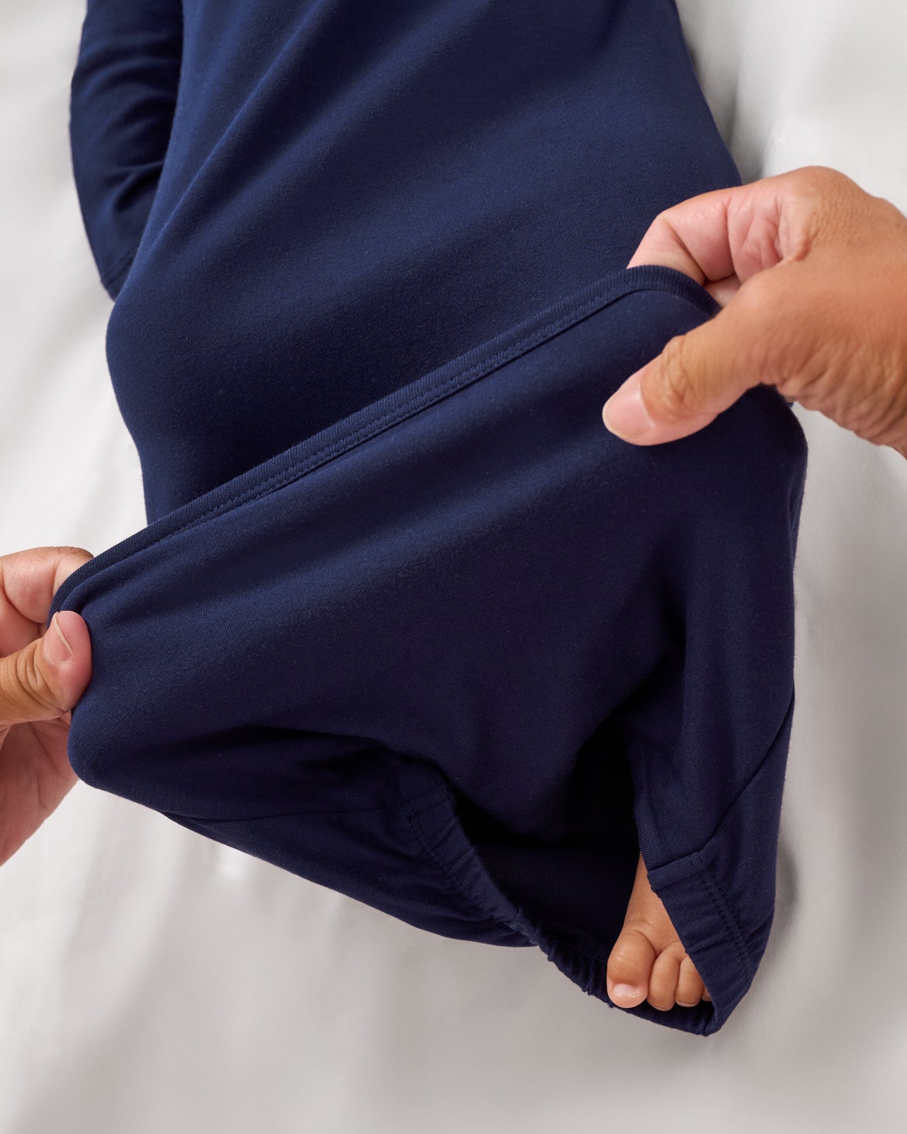 Adult demonstrating the envelope sweep on the My First Hanukkah Infant Gown