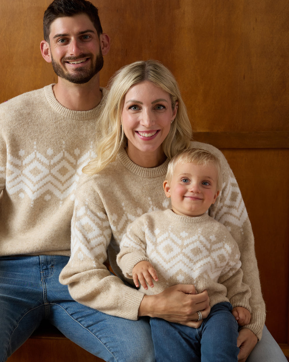 Family of three wearing matching Neutral Fair Isle Sweaters