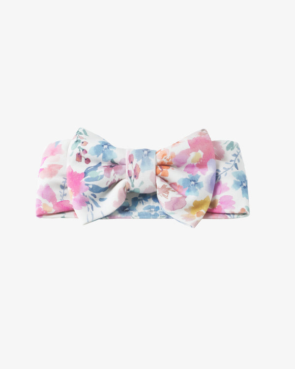 Flat lay of the Tiny Blooms Luxe Bow Headband
