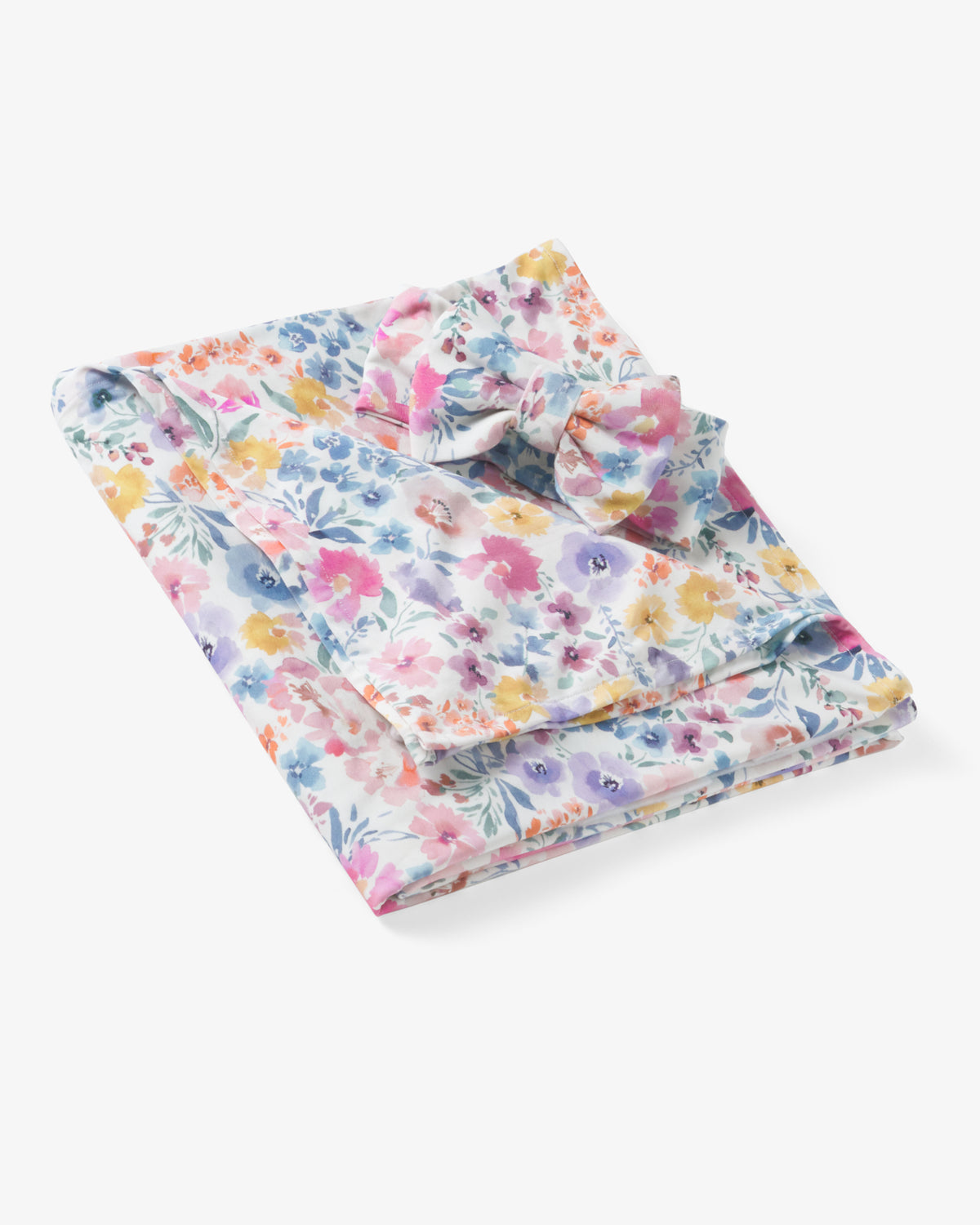 Flat lay of the Tiny Blooms Swaddle & Luxe Bow Headband Set