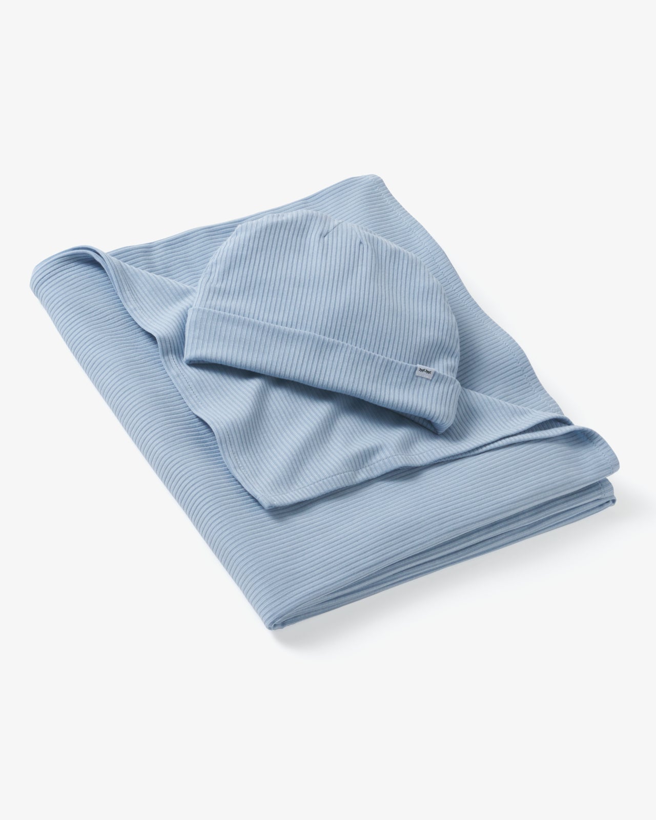 Flat lay of the Light Fog Baby Ribbed Swaddle & Infant Beanie Set