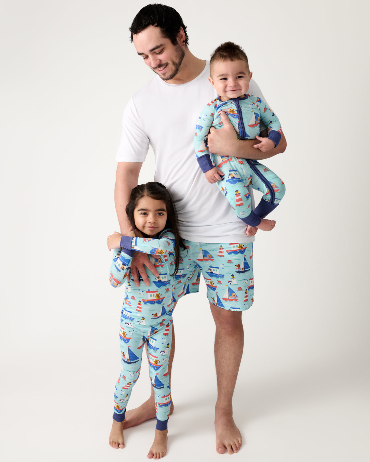 Father and two kids wearing matching Nautical Paws bamboo pajamas