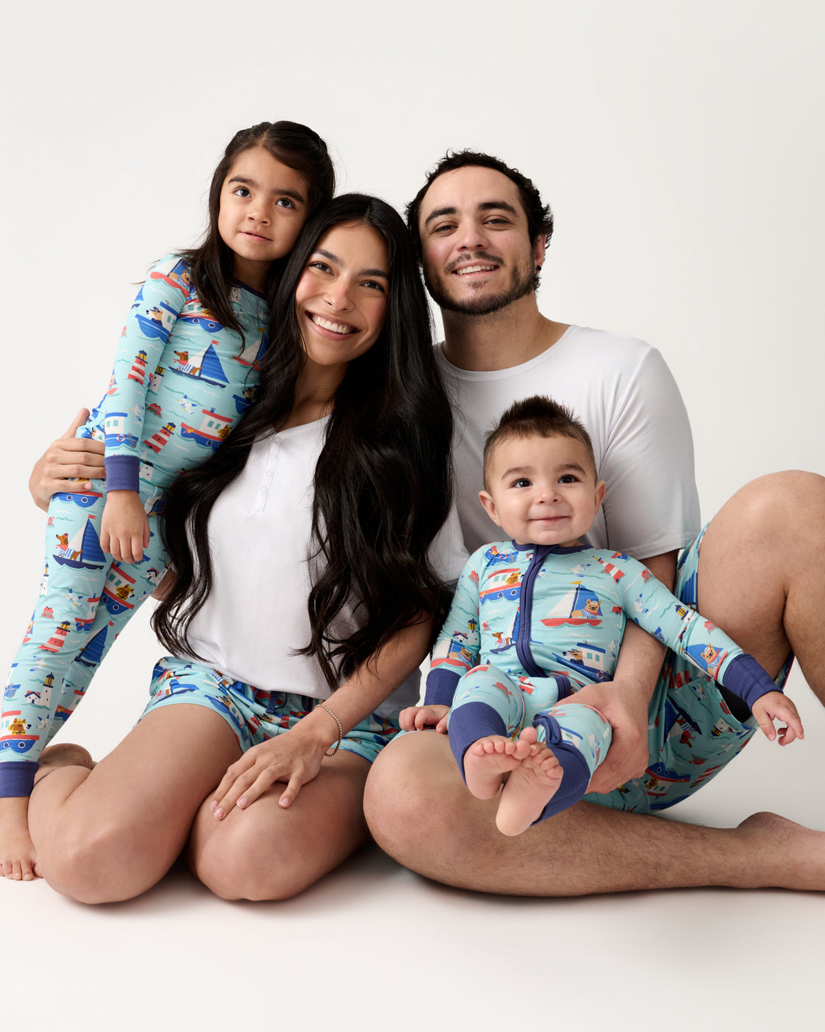 Family of four wearing matching Nautical Paws pajamas