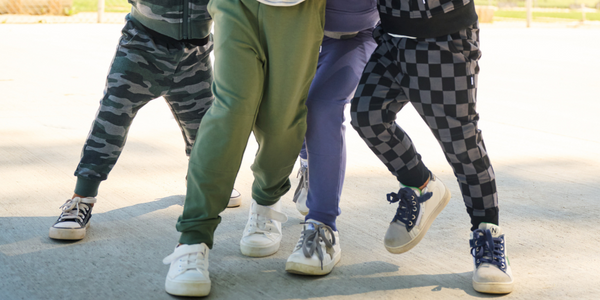 Close up of four children wearing Little Sleepies' joggers
