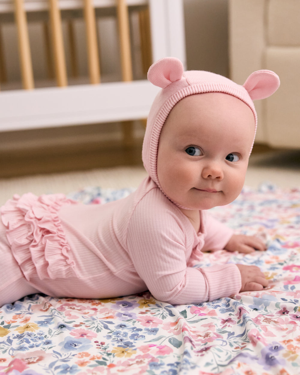 Baby wearing the Prima Pink Bear Bonnet