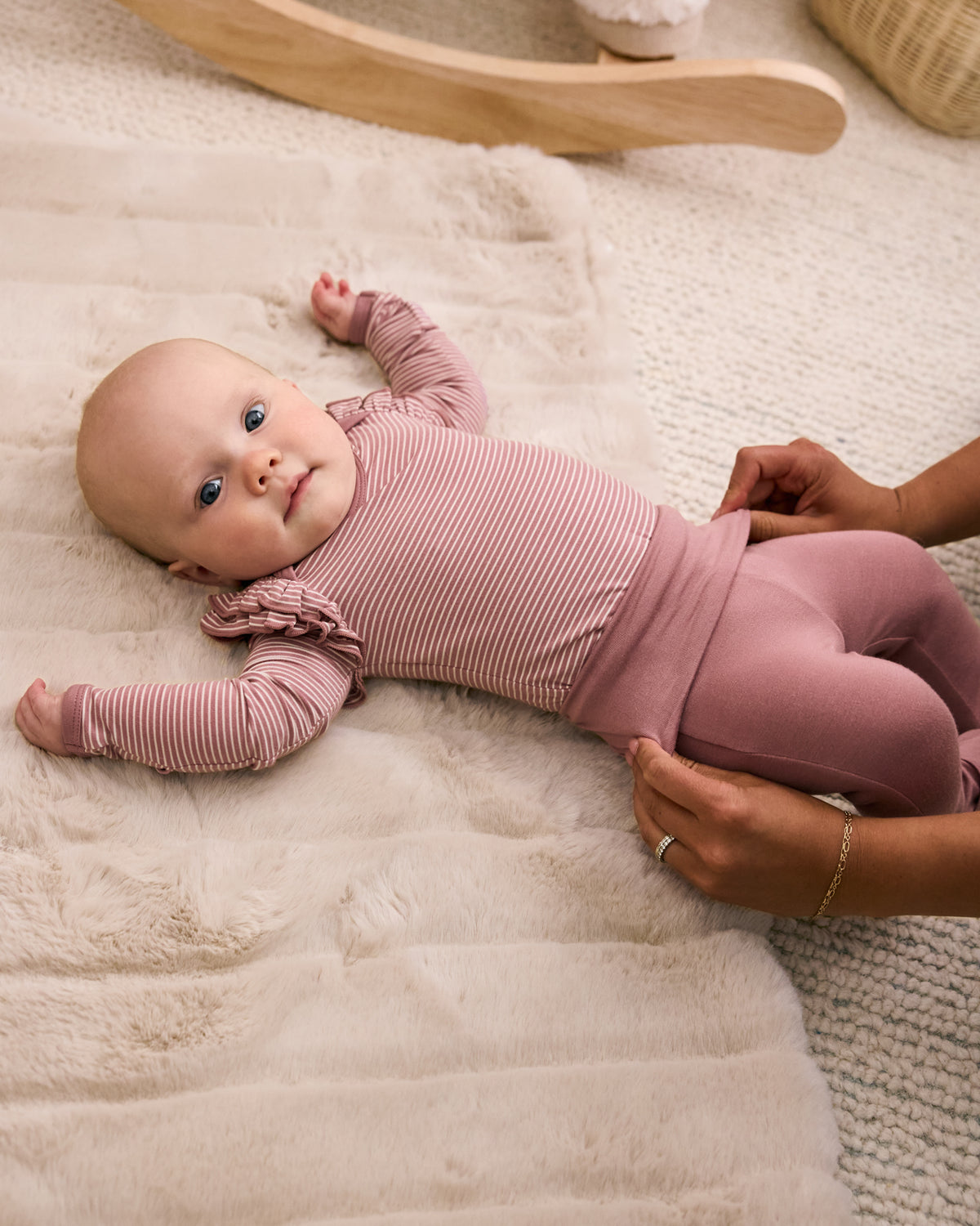 Aerial view of adult adjusting the waist fold over detail on the Rosewood Fold-Over Legging