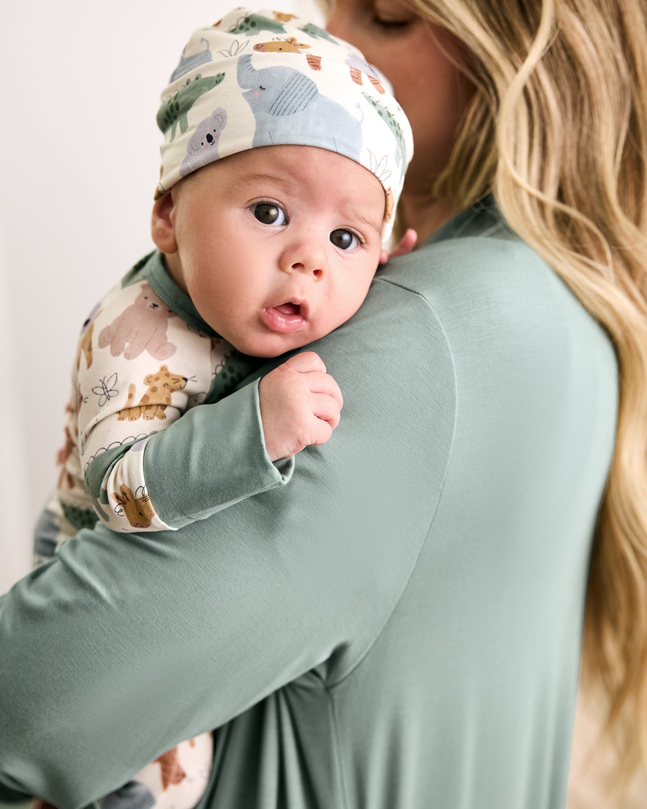 Mother holding baby wearing the Sweet Safari Infant Beanie