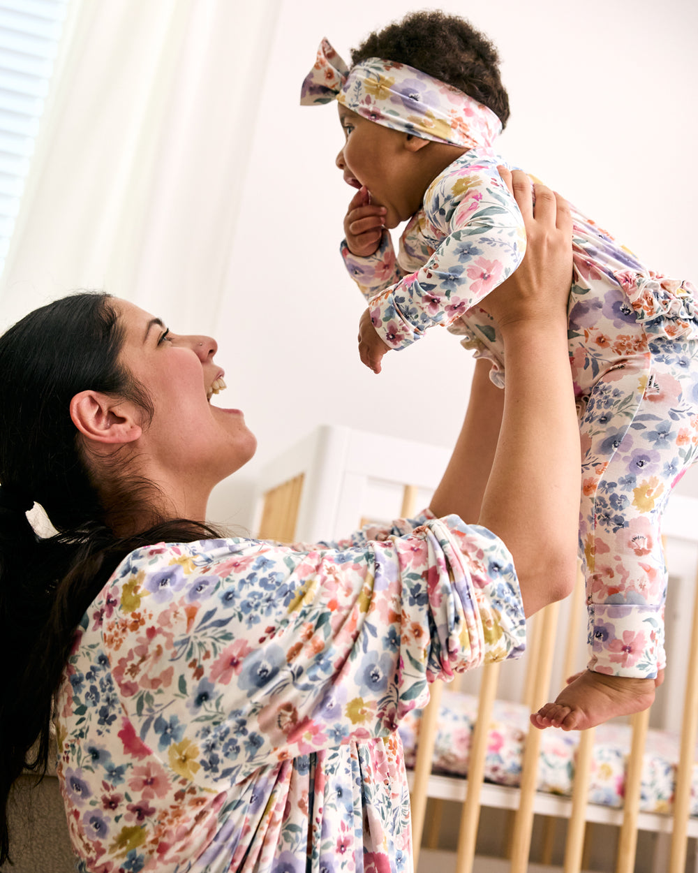 Mother and newborn wearing matching Tiny Blooms floral pajamas