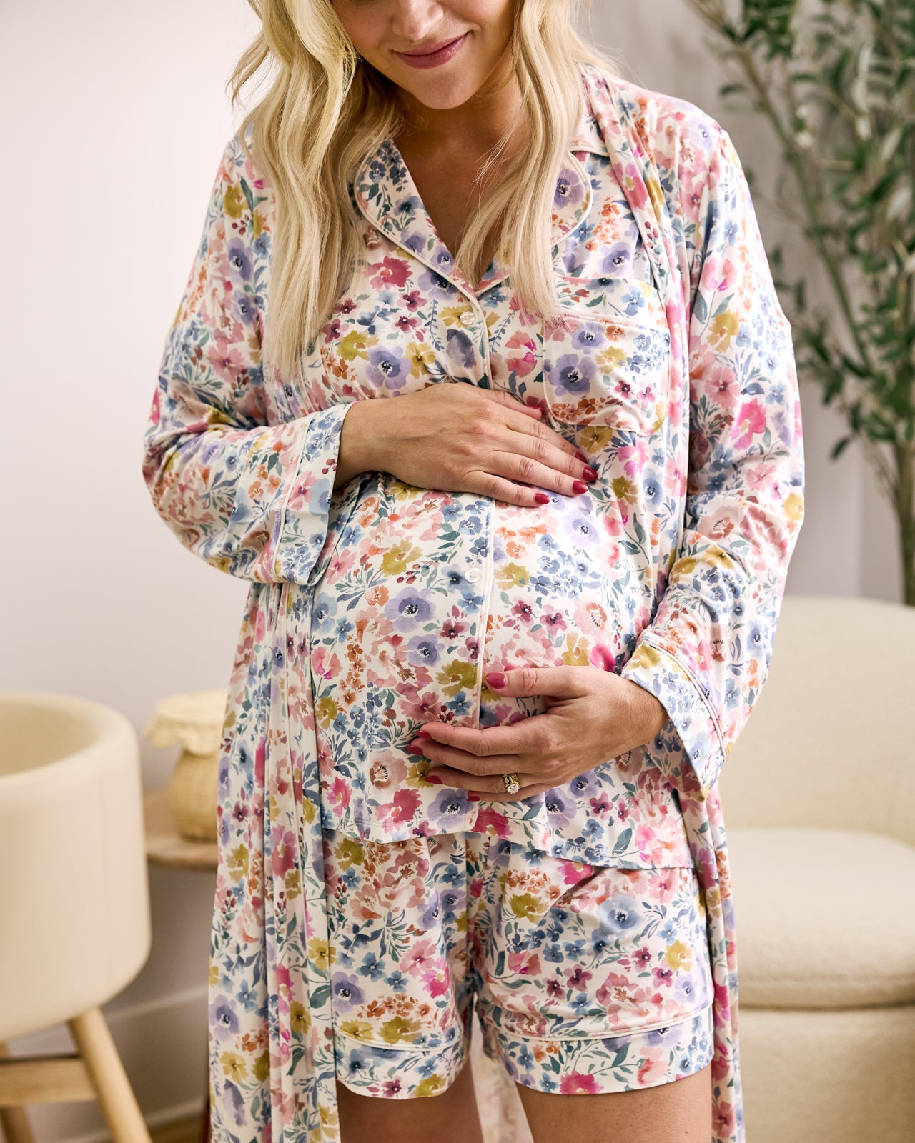 Woman wearing the Tiny Blooms Women's Short Sleeve Short Pajama Set with a matching floral robe