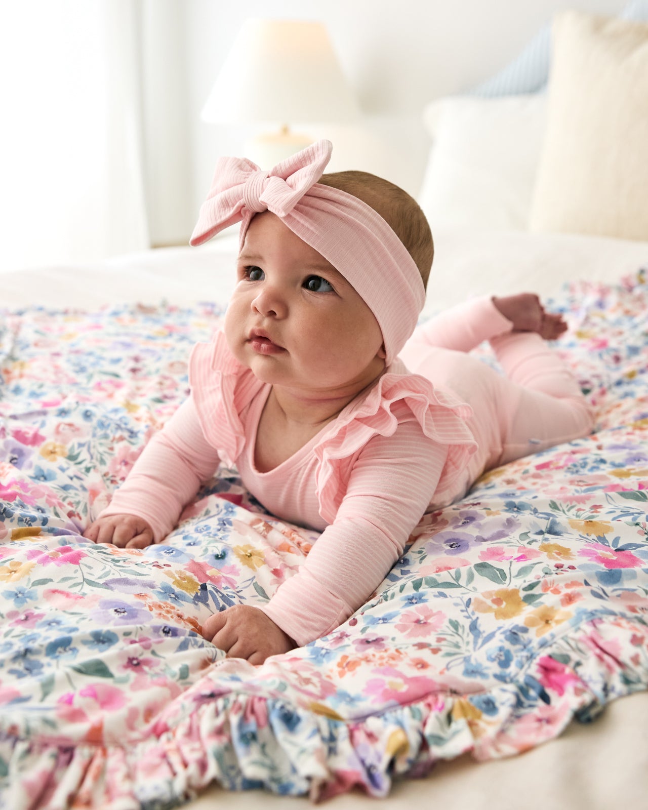 Baby laying on the Tiny Blooms Ruffle Mini Cloud Blanket