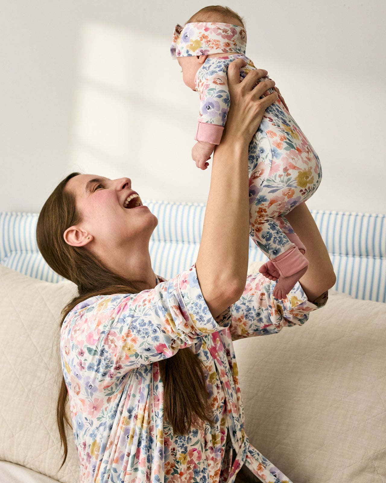 Mother wearing the Tiny Blooms Women's Robe holding baby in a matching floral zippy