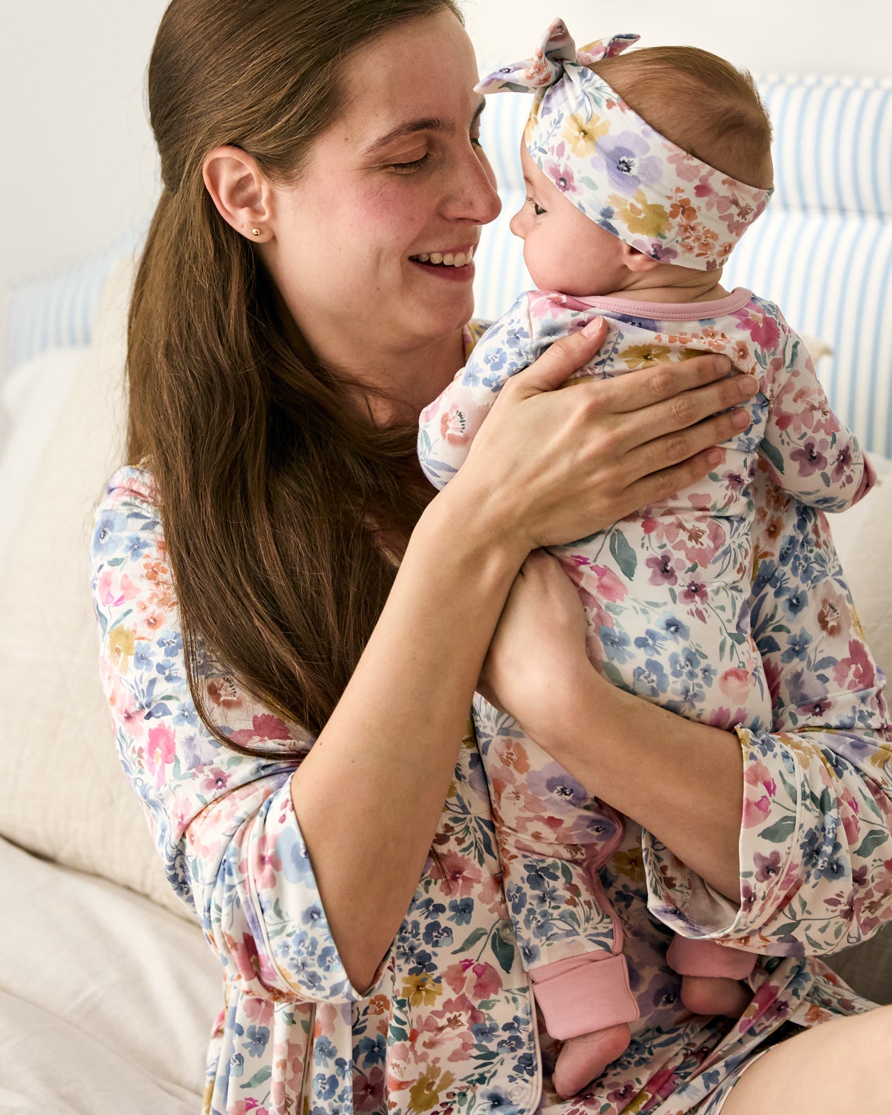 Mother wearing the Tiny Blooms Women's Robe holding baby wearing the Tiny Blooms Crescent Zippy