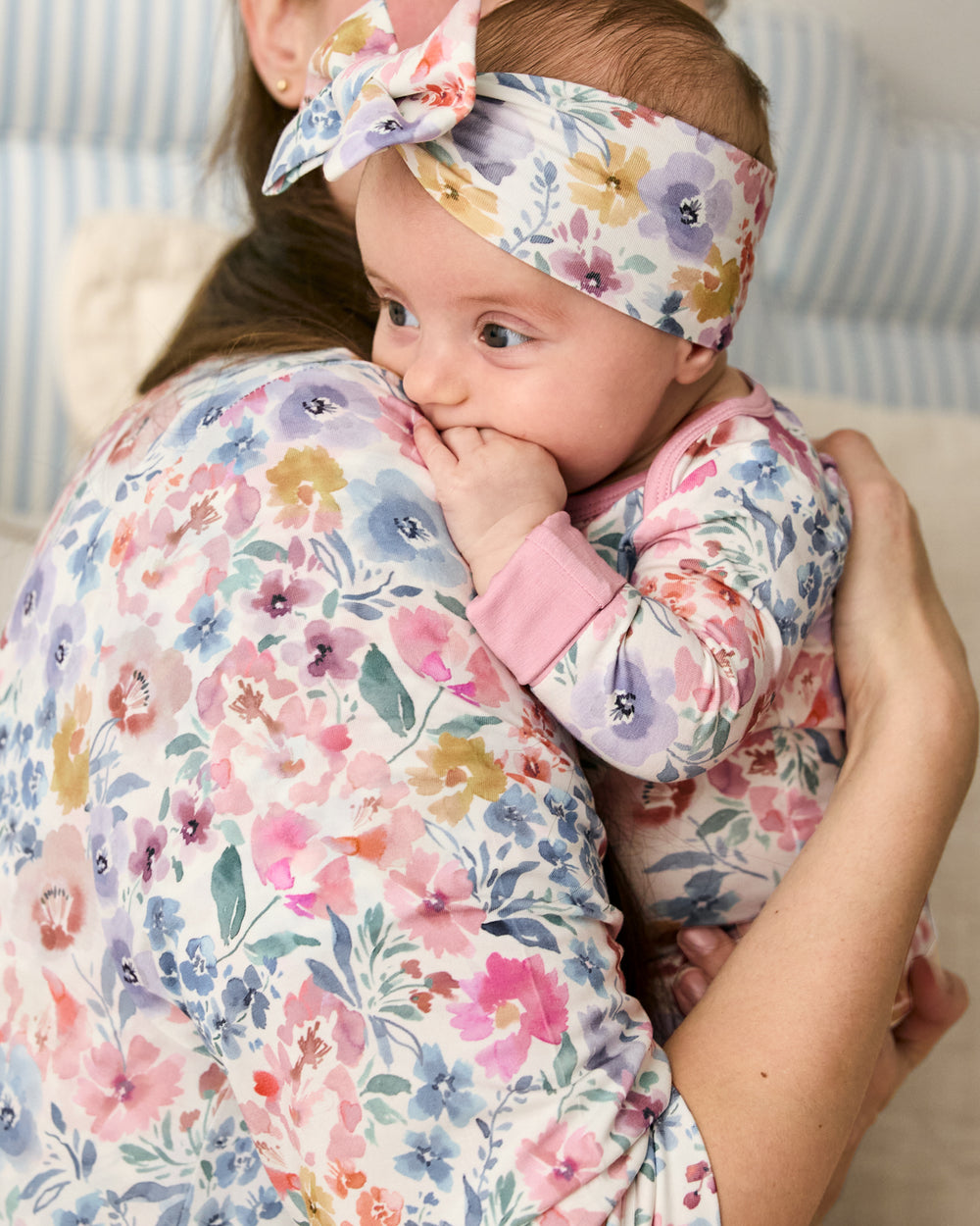 Mother holding baby wearing the Tiny Blooms Luxe Bow Headband