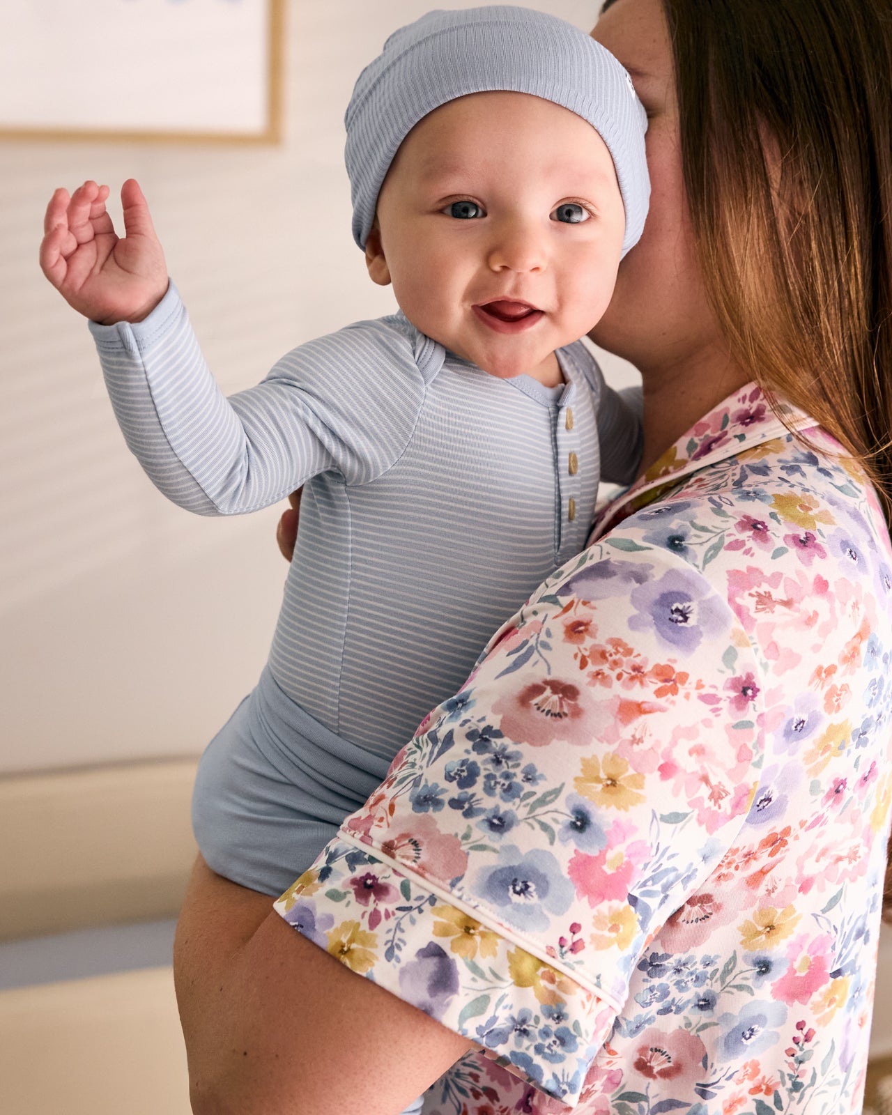 Mother holding newborn wearing the Light Fog Stripe Henley Bodysuit