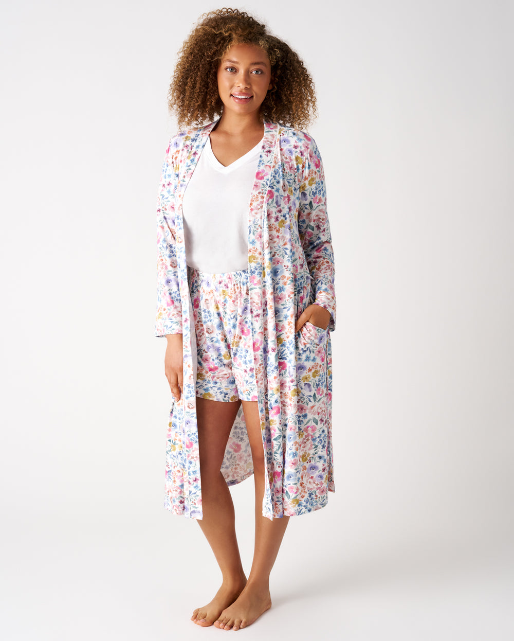 Woman wearing the Tiny Blooms Women's Robe layered over matching shorts