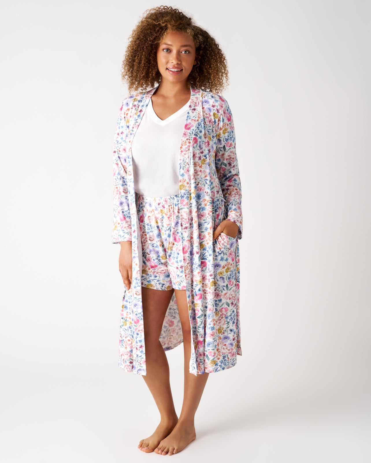 Woman wearing the Tiny Blooms Women's Robe layered over matching shorts