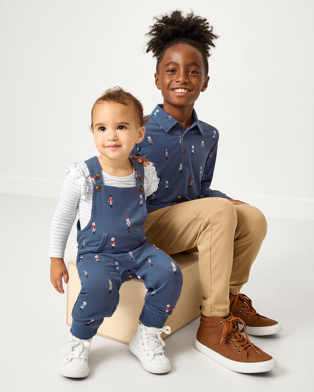 Two children wearing matching Nutcracker March play styles