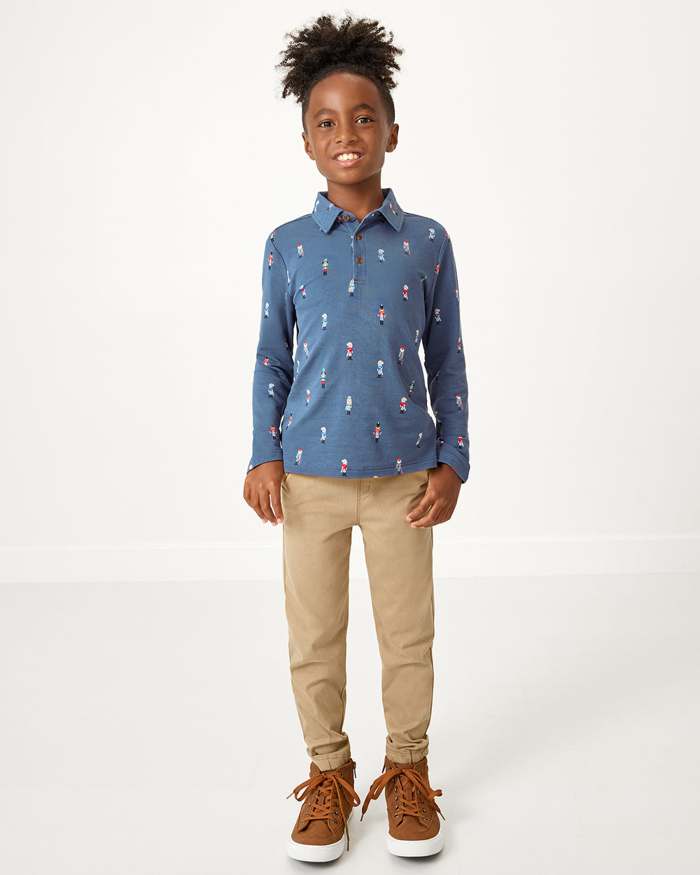Boy wearing the Nutcracker March Polo Shirt with khaki pants