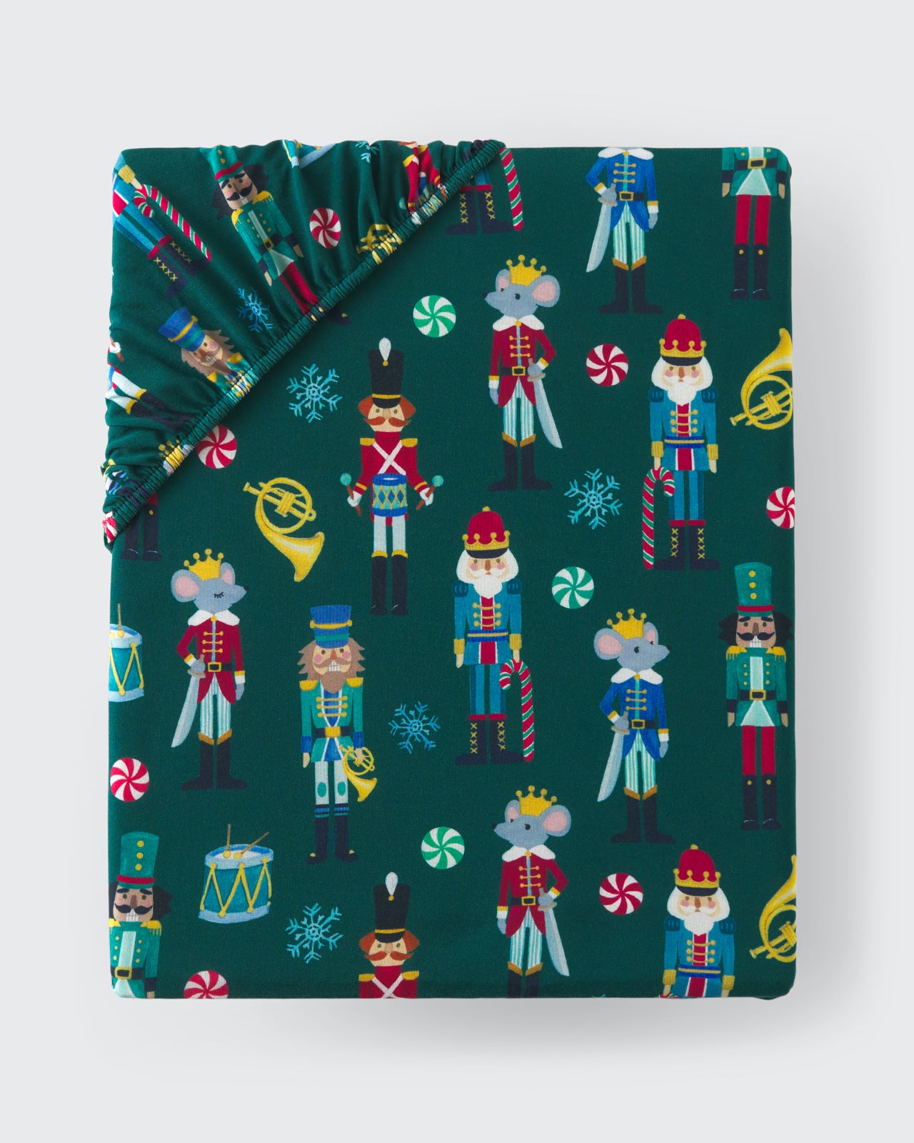 Flat lay of the Nutcracker March Fitted Crib Sheet