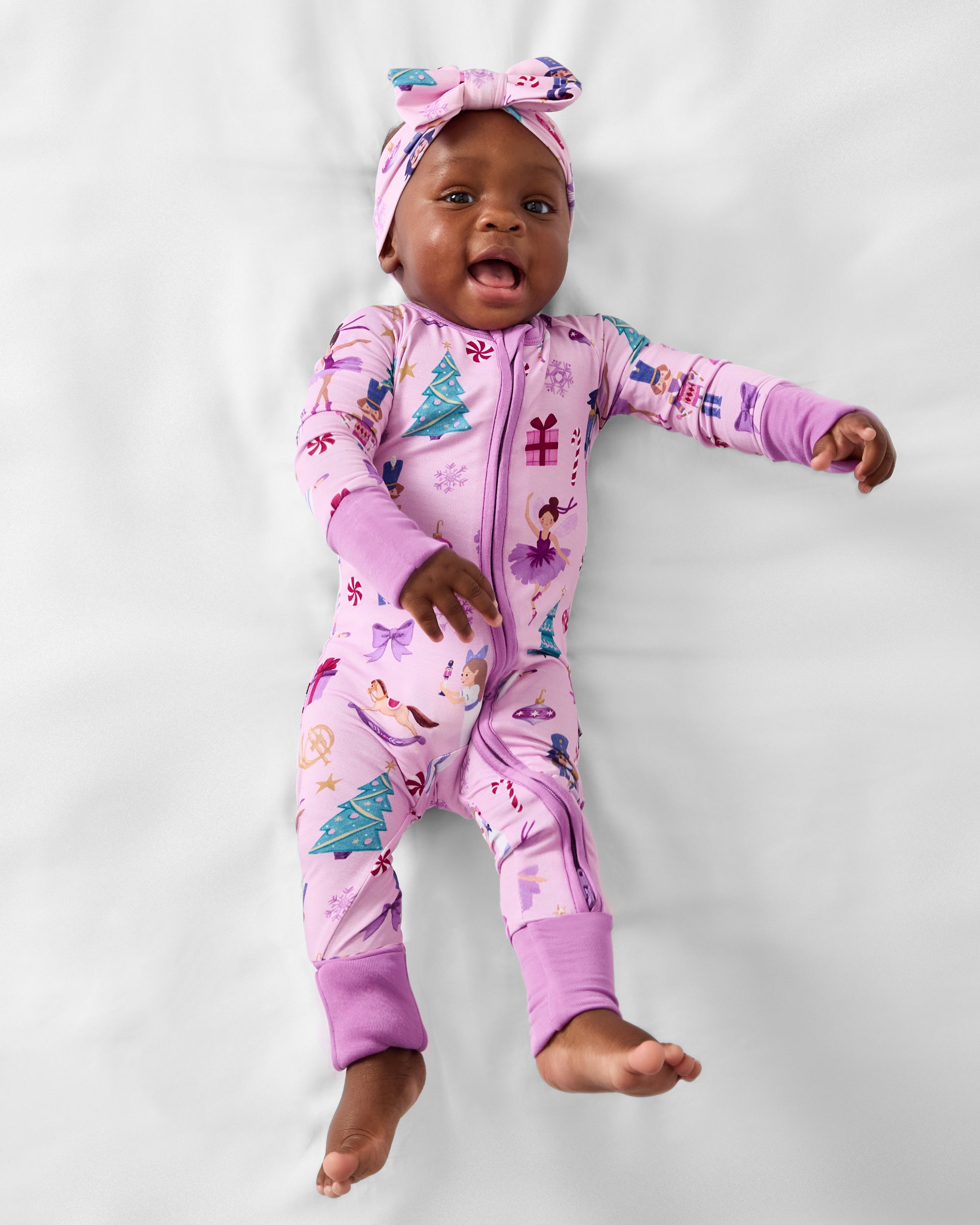 Baby wearing the Nutcracker Ballet Luxe Bow Headband with a matching luxe bow headband