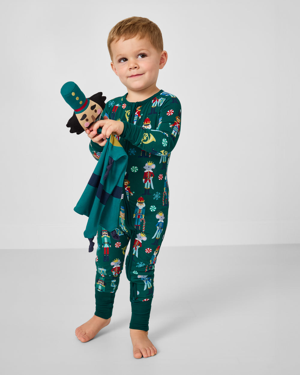 Boy holding the Hans the Nutcracker Sleepyhead Lovey