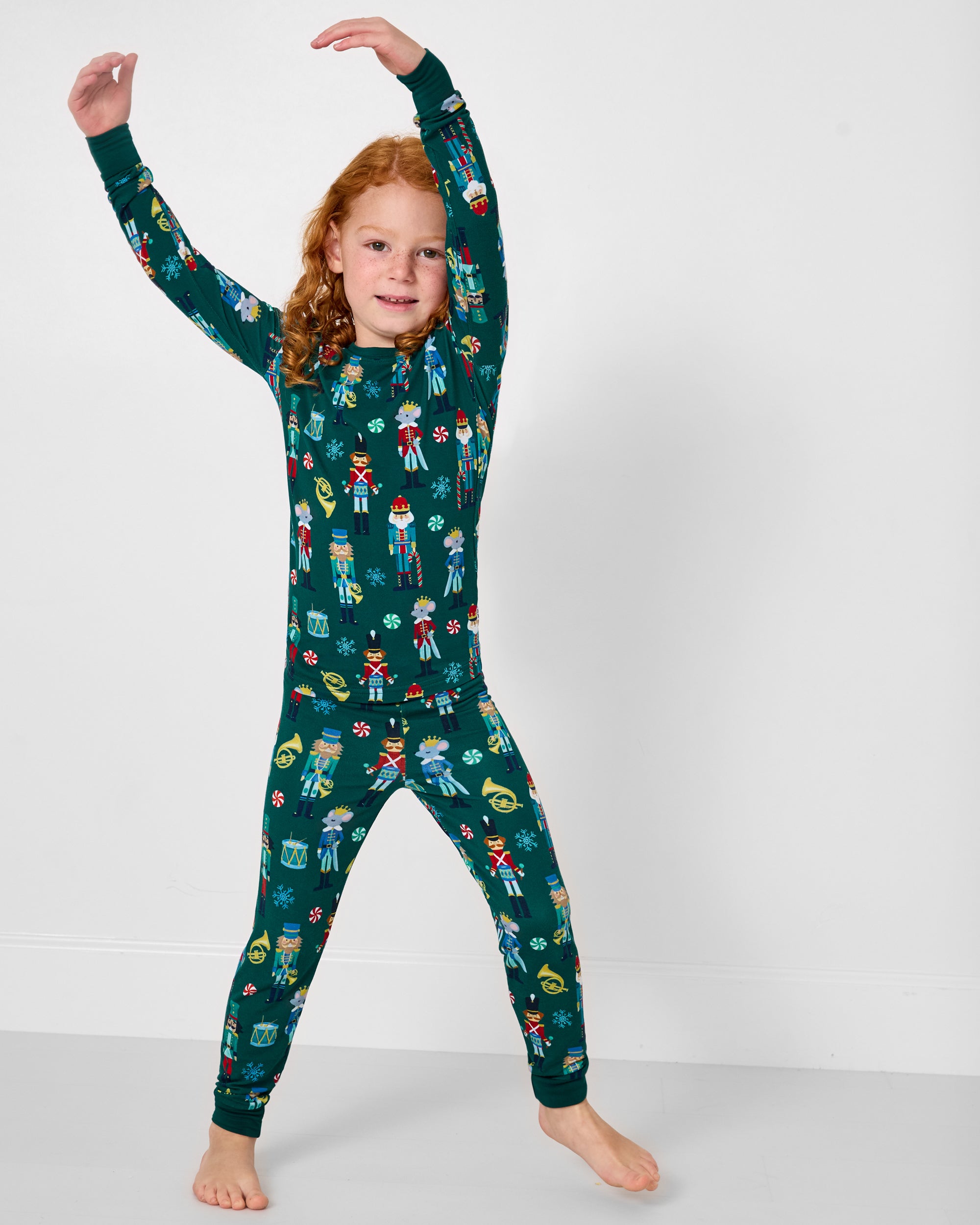 Posing girl wearing the Nutcracker March Two-Piece Pajama Set