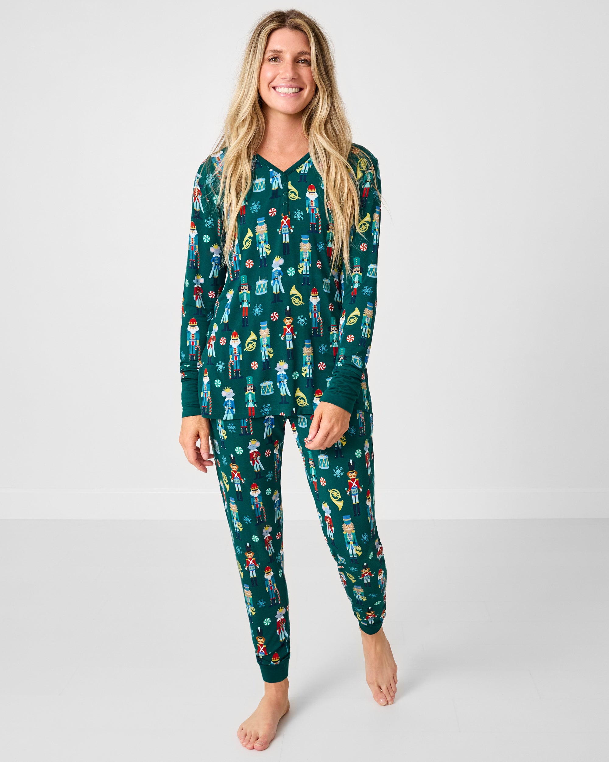 Woman wearing the Nutcracker March Women's Long Sleeve Pajama Top and coordinating bottoms