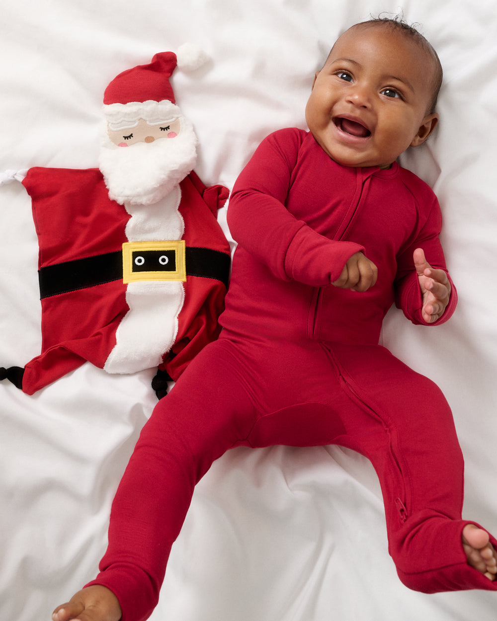 Baby laying with the Nick the Santa Sleepyhead Lovey